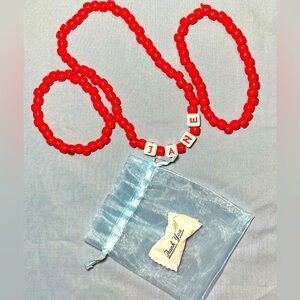 3-pc red bead set with the name Jane in block letters.